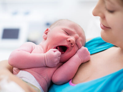 Woman Holding Newborn Child