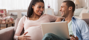 Pregnant couple with computer