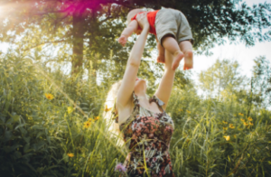 Mother holding toddler in the air