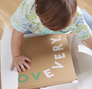 Toddler opening a box