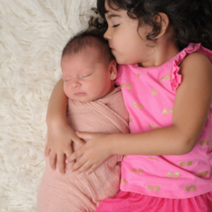 infant and toddler cuddling