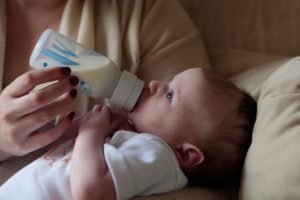 Baby being feed from a bottle