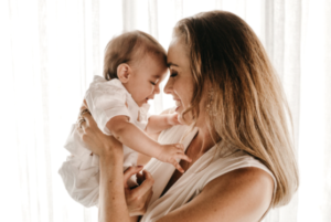 Blonde mother and child in matching beige outfits