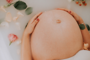 Pregnant belly in a bubble bath 
