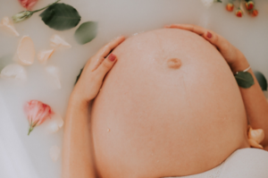 Pregnant belly in a bubble bath