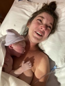 Mother holds newborn skin to skin just after birth