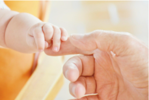 photo of baby hands holding dad's finger