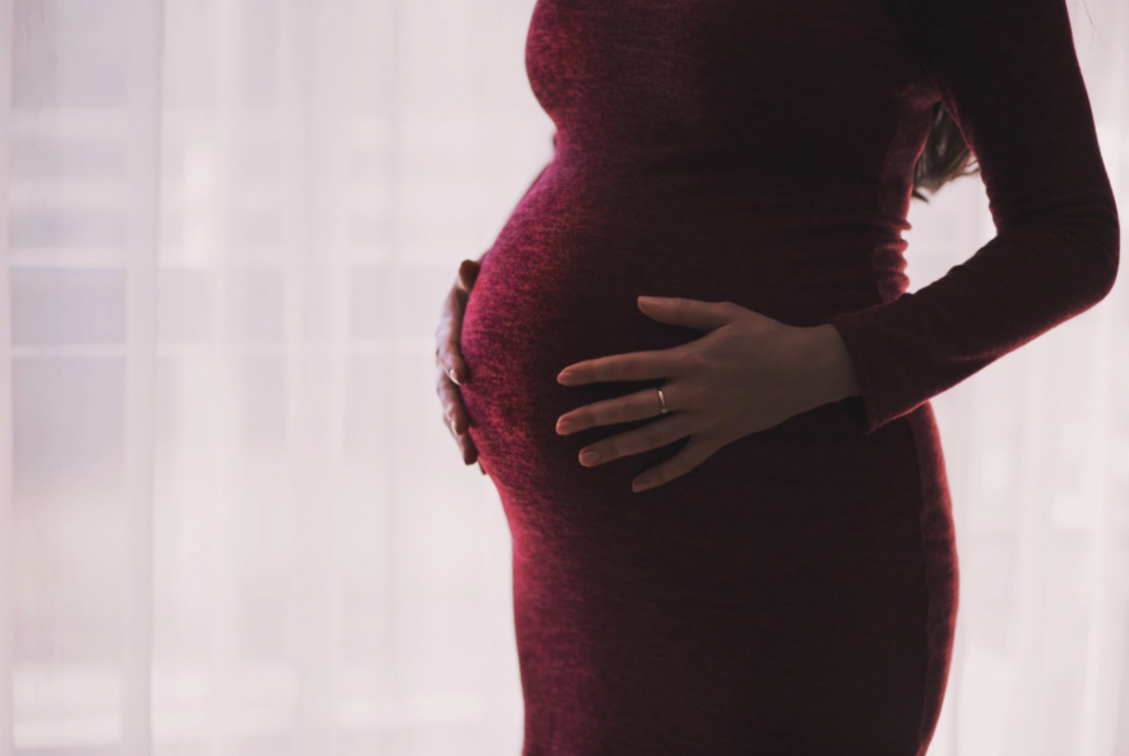 pregnant belly in a red dress