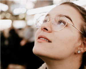 Woman in glasses looking at the sky