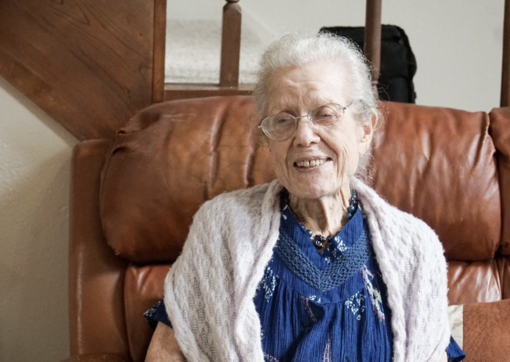 Old woman with a blue dress and white shawl