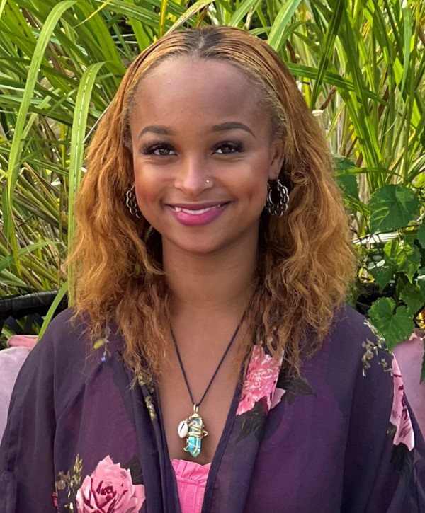 Pretty Caribbean woman with in a purple kimono and pink top