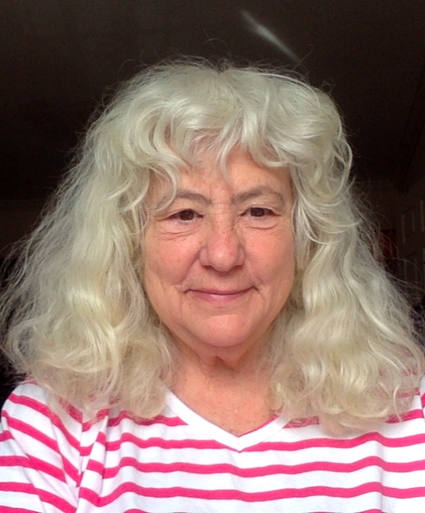 Woman with white hair in a pin and white stripped shirt 